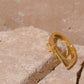 An Image of the Estelle ring sitting on bricks.